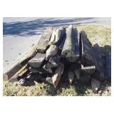 Wood Fence posts Pile, mostly half rounds,