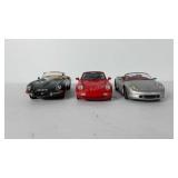 Toy cars, includes two Porsche and one Jaguar,