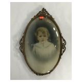Early Child portrait in metal oval frame with