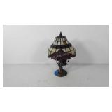 Lamp with leaded glass shade and cast metal base,