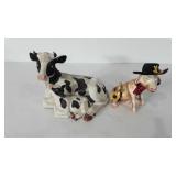 Cow decor, two statues, one is missing horns and