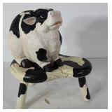 Wooden cow print stool and cow figurine