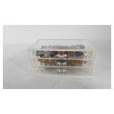 Clear three drawer jewelry box with contents, 9"