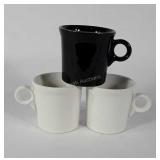 Three Fiesta mugs, two white, one black