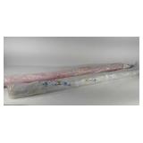 Two rolls of decorator fabric, one with seashell