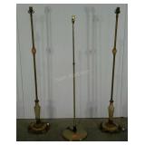 Three floor lamps, two with heavy metal base and