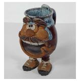 Footed pottery face mug, signed