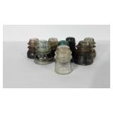 Eight glass insulators, some are chipped