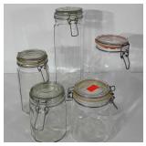 Five glass canisters, 6"-13"