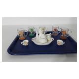 Five M&M shot glasses and small tea set