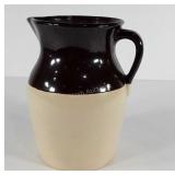 Brown over white stoneware pitcher, stands 10"
