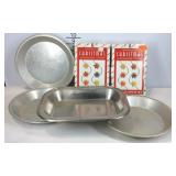 Four baking pans and two boxes of Christmas