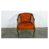 Groovy orange caned arm chair