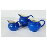 Three ceramic blue pitchers made in