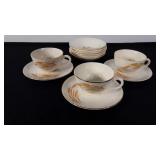 Porcelain cups, saucers, and small bowls, all