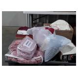 Skid with pink bedspread,  bed clothes,  pillows,