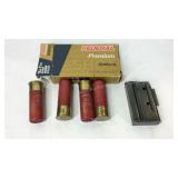 Four 12ga 2 3/4in 00 buck ammo shells and a clip