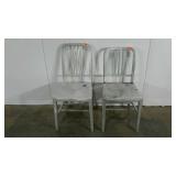 Two aluminum chairs, similar in stule, one is