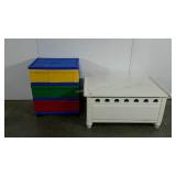 Toy chest and plastic storage bin tower full of