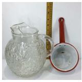 Clear glass pitcher and a red and white enameled