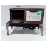 Doll sized kitchen stove and tin box, stove plugs
