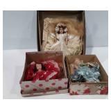 Three dolls in boxes