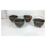 Four mini cast iron kettles