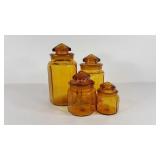 Four amber glass canisters, two chips and tape