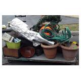Skid of water hose,  planters, paper , drainhose,