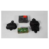 Two cast iron match holders and two metal trinket