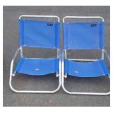 Two Rio Beach collection chairs one has a stain