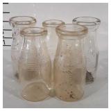 Five glass half pint milk jugs