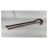Two canes, one metal, one carved wood