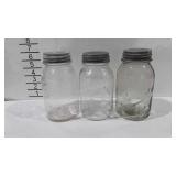 Three Mason jars with zinc lids and milk glass