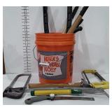 Tools, five gallon bucket with hand saws, level,