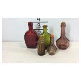 Five mini glass bottles