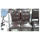 Two upholstered vinyl dining chairs