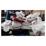 Large group of bed linens and home decor pillows