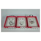 Three necklace and earring sets, boxed
