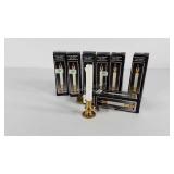 Seven brass battery candlesticks, with boxes