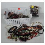Basket of costume jewelry, includes mostly