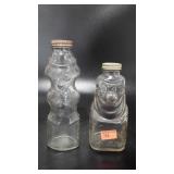 Two glass figural bottle coin banks, 7.5 and 9"