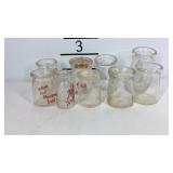 Nine mini dairy advertising bottles