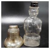 Two glass coin banks, liberty bell and Abe