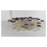 Glass jars, mostly mason jars and jelly jars,