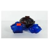 Three glass pig coin banks, two cobalt blue,