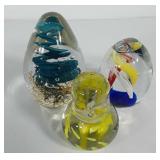 Three glass art paperweights, includes bird,