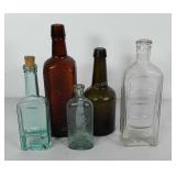 Five glass bottles, includes Hood