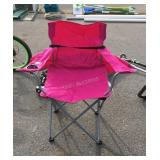 Pink folding chair, some fading on back