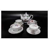 Teapot and four cup and saucers, Limoges and